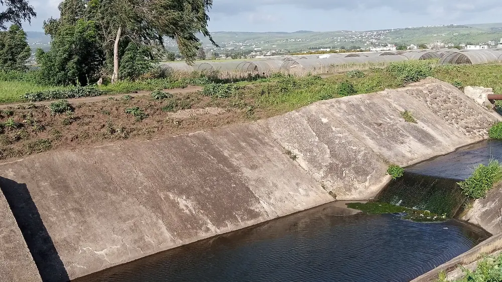 Concrete-lined irrigation canal feeding a farm distribution network